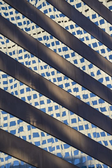 Reflections in window of skyscraper in Denver, Colorado