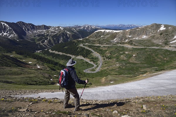 Hiker looking at view of mountains at Loveland Pass in Colorado