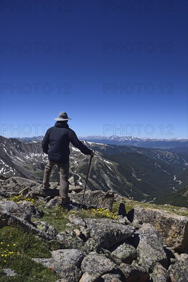 Hiker looking at view of mountains at Loveland Pass in Colorado