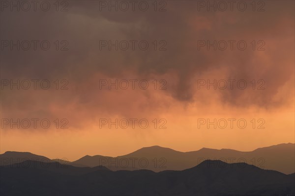 Distant wildfires and mountains at sunset in Denver, Colorado