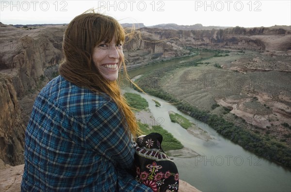 Smiling woman sitting at the Grand Canyon