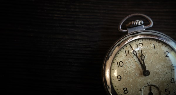 Antique pocketwatch on wooden table