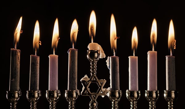 Lit candles in menorah