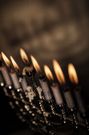 Lit candles in menorah