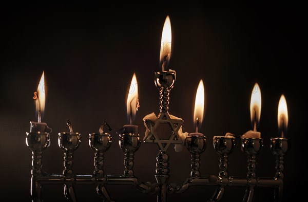 Lit candles in menorah