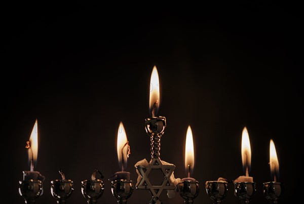 Lit candles in menorah