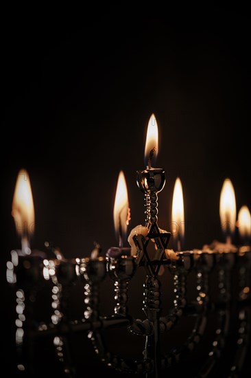 Lit candles in menorah