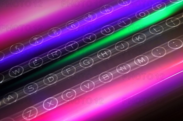 Colorful light trails over keys of typewriter