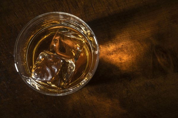 Glass of whiskey with ice cube