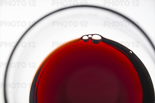 Glass of red wine on white background