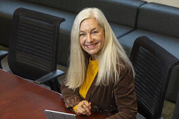 Smiling businesswoman sitting in conference room