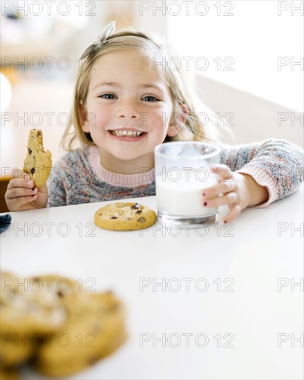 Girl eating milk and cookies