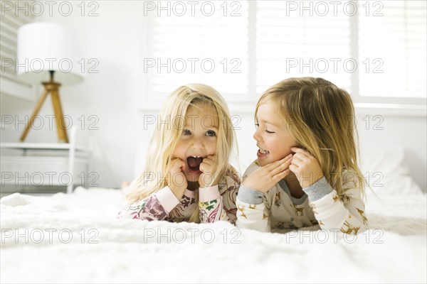 Sisters lying on bed