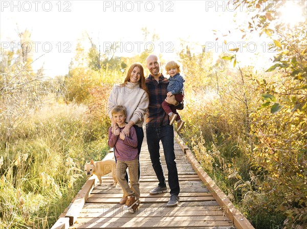 Smiling family on forest boardwalk