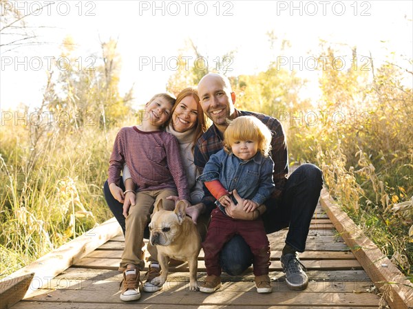 Smiling family on forest boardwalk