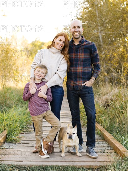 Smiling family on forest boardwalk