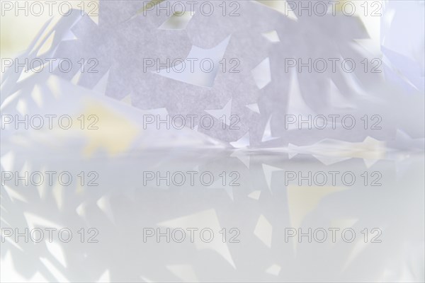 Paper snowflake on glass table