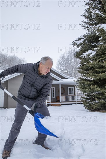 Senior man shoveling snow