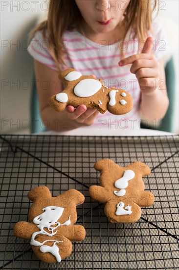 Girl eating gingerbread man