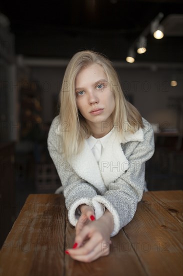 young woman sitting at cafe table