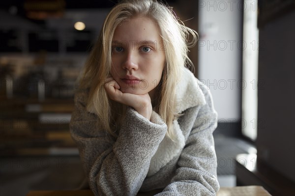 young woman with wool coat in cafe