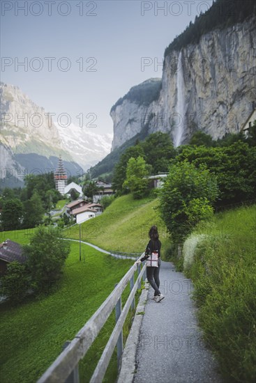 young woman on path by mountain