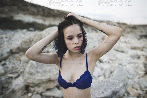 young woman with blue bra on beach
