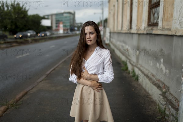 young woman on city sidewalk