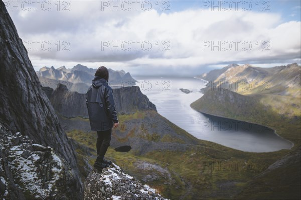 young man hiking on mountain in Norway