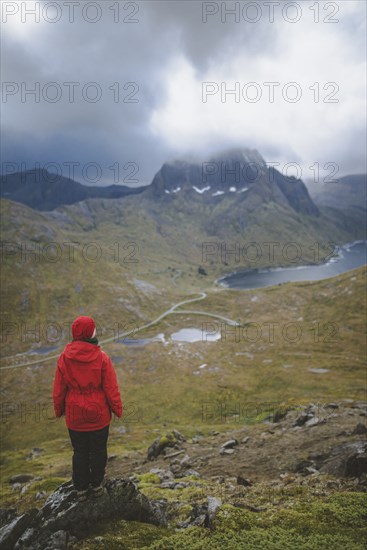 Woman in red jacket on mountain