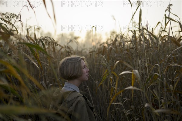 young woman in field of long grass