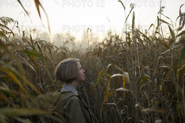 young woman in field of long grass