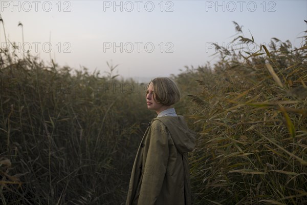 young woman in field of long grass