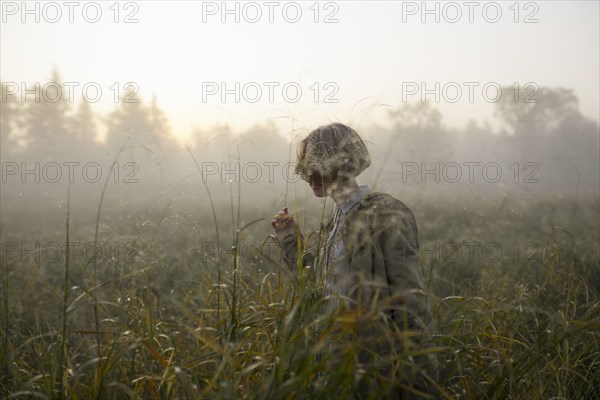 young woman in field of long grass
