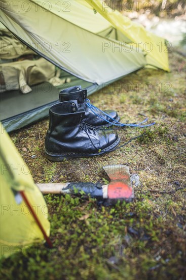 Boots and hatchet by tent