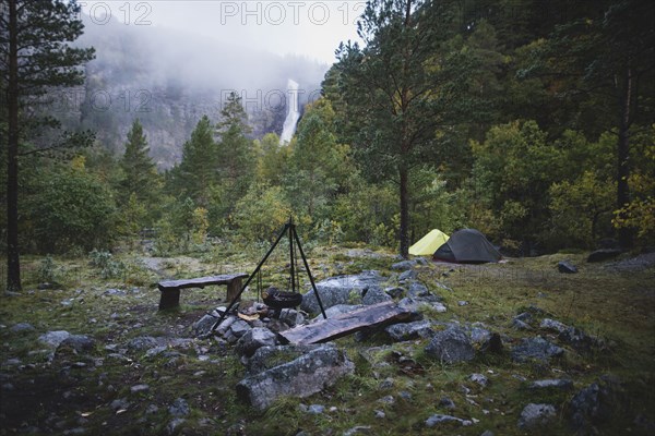 Cooking pot on tripod above campfire