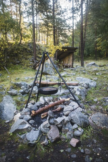 Cooking pot on tripod above campfire