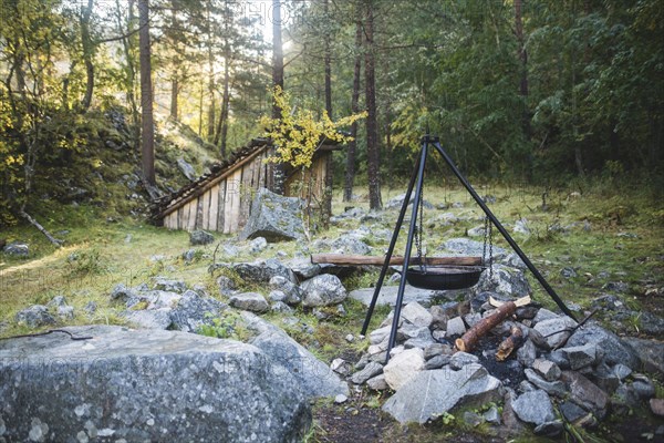 Cooking pot on tripod above campfire