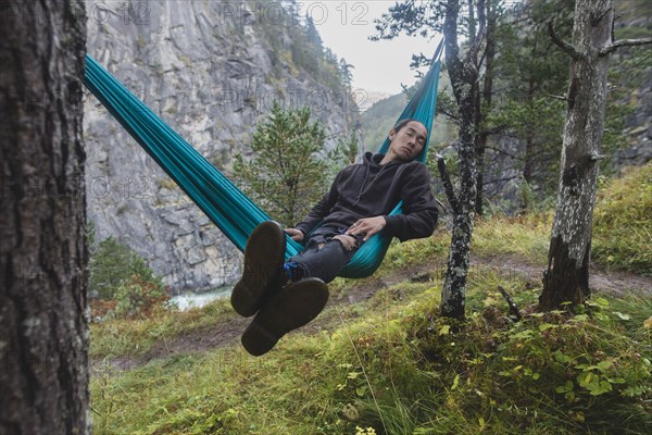 young man resting in hammock