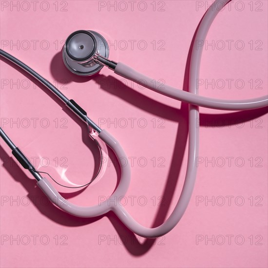 Stethoscope on pink background