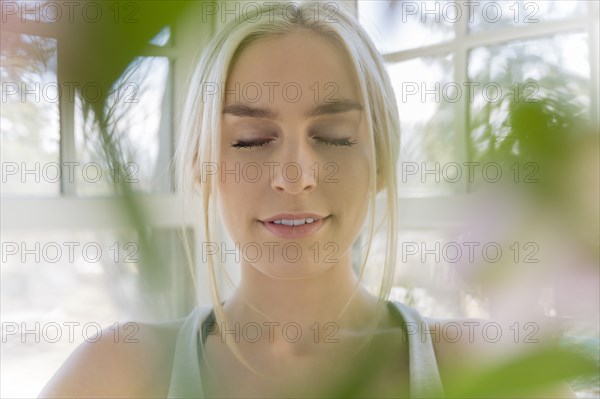 Portrait of young blonde woman with eyes closed