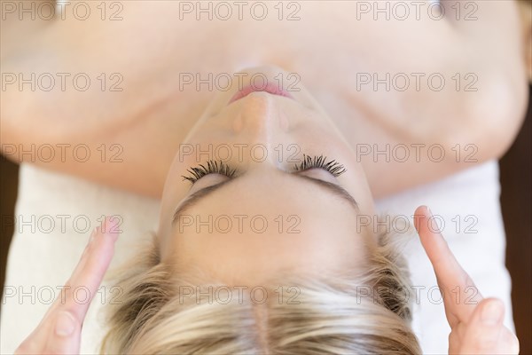 Woman getting head massage during spa treatment