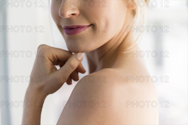 Close up of woman's smile and bare shoulder