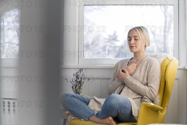 Woman meditating at home