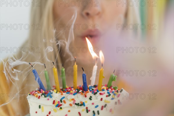 Woman blowing out birthday candles