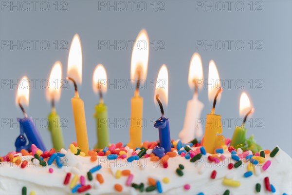 Lit birthday candles on cake