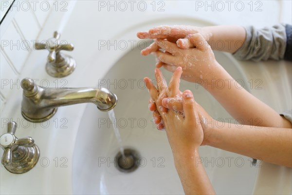 Close-up of children (4-5, 6-7) washing hands