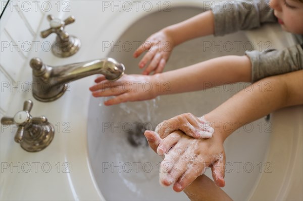 Close-up of children (4-5, 6-7) washing hands