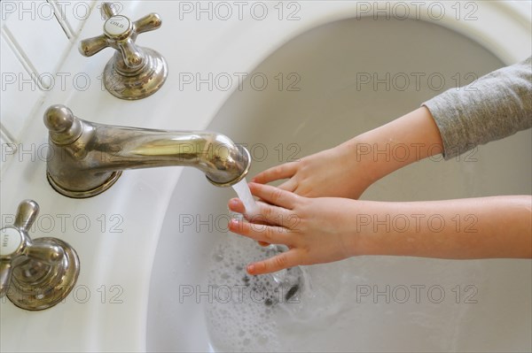 Close-up of boy (4-5) washing hands