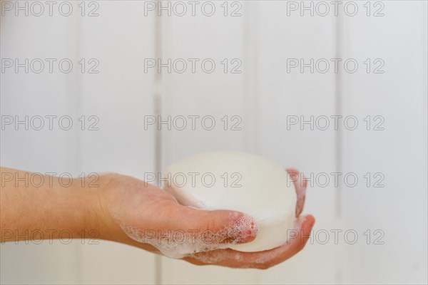 Close-up of girls (6-7) hand holding soap